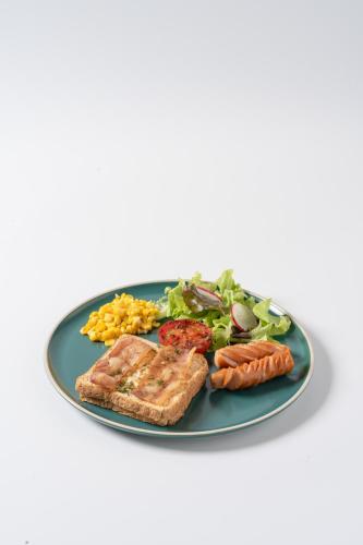 a plate of food with meat and vegetables on it at Sugar Ohana Poshtel in Kata Beach