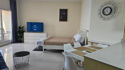 a bedroom with a bed and a television in it at Full Sea view studio in Ras al Khaimah