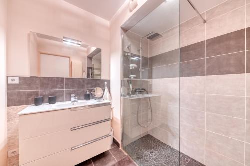 uma casa de banho com um lavatório e um chuveiro em Superbe appartement à Decines em Décines-Charpieu