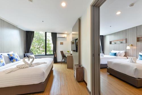 Giường trong phòng chung tại Bedever Boutique Bangkok Hotel - BTS Phra Khanong