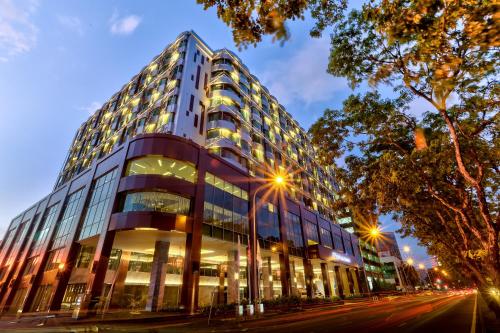 a tall building on a city street at night at Hilton Kota Kinabalu in Kota Kinabalu