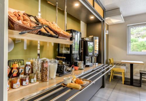 a bakery with a counter with bread and pastries at B&B HOTEL Montpellier 1 in Saint-Jean-de-Védas