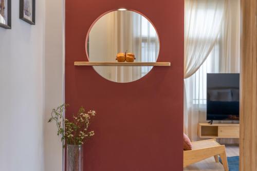 a mirror on a red wall in a living room at Viewing Mount with Jun in Lijiang