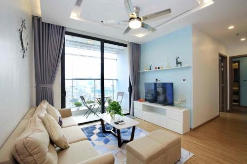 a living room with a couch and a tv at Investland- Vinhomes Metropolis one, two, three, four bedrooms in Hanoi