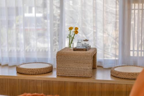 a table with three baskets and a vase of flowers on it at Viewing Mount with Jun in Lijiang
