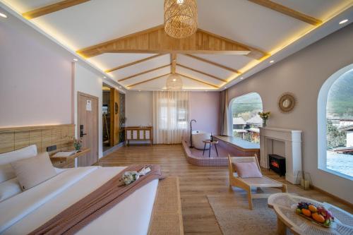 a bedroom with a large bed and a living room at Viewing Mount with Jun in Lijiang