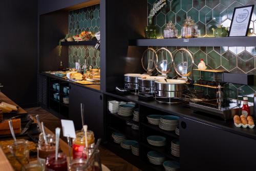 a restaurant with a buffet of food on display at Mercure Valenciennes Centre in Valenciennes