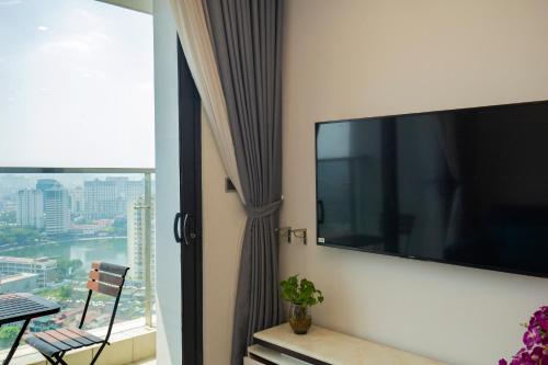 a living room with a large flat screen tv on a wall at Investland- Vinhomes Metropolis one, two, three, four bedrooms in Hanoi
