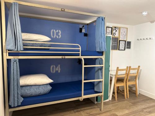 a bunk bed with blue bunk beds in a room at Smart Camden Inn in London
