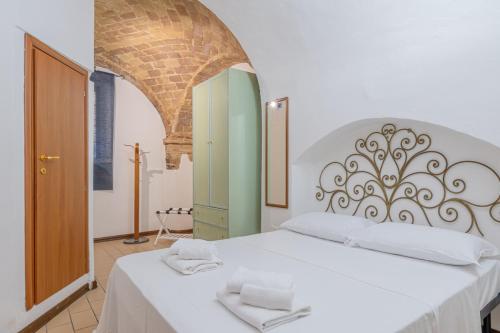 a bedroom with a white bed with two towels on it at Leone Acciaioli - YourPlace Abruzzo in Ortona