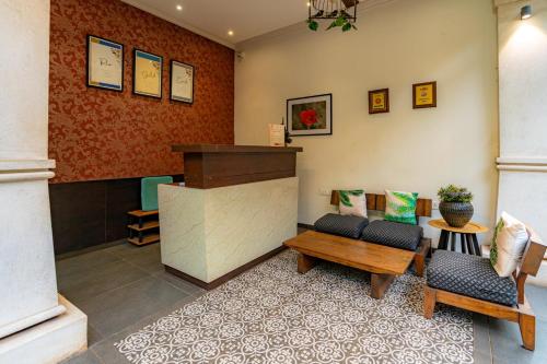 a waiting room with two chairs and a table at Riva Gold Coast in Candolim