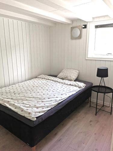a bedroom with a bed in a room with a window at Cozy apartment near city centre in Stavanger