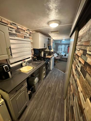 a kitchen with a sink and a counter top at Disabled 4 Berth in Ingoldmells