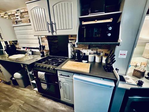 a kitchen with a stove and a sink at Disabled 4 Berth in Ingoldmells