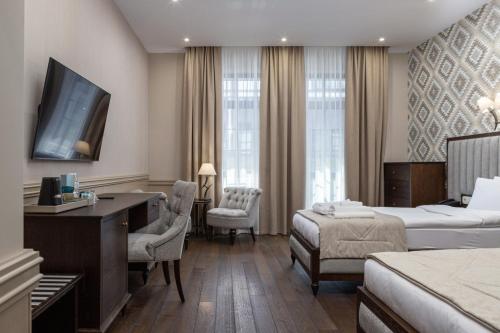 a hotel room with a bed and a desk at Crona SPA Karpaty in Skhidnitsa
