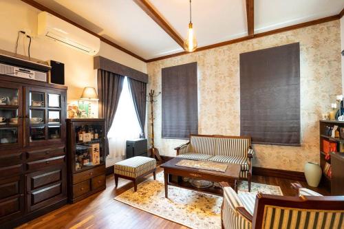 a living room with a couch and a table at Rakumankan in Kyoto