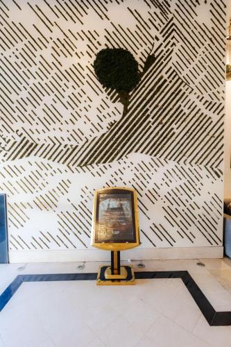 a small television in front of a wall with a mural at WINDSOR HOTEL CITY CENTER in Casablanca