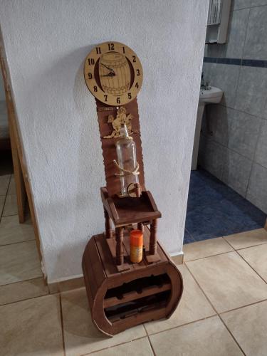 a wooden clock sitting on the floor in a bathroom at A&M Alojamiento - Lluvia de Oro 2554 in Puerto Rico