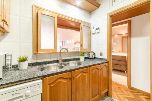 a kitchen with a sink and a mirror at Confort Barcelona Rentals in Barcelona