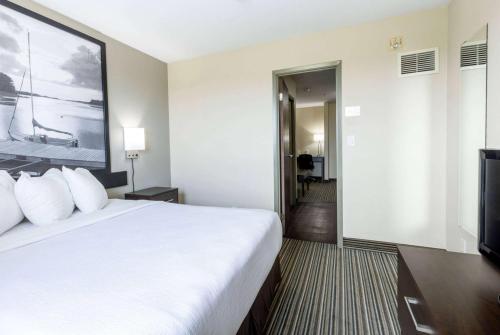 a hotel room with a large bed and a flat screen tv at Super 8 by Wyndham Truro NS in Truro
