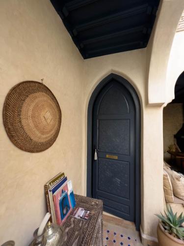 a black door in a room with a table at Riad Jonan & Spa in Marrakech