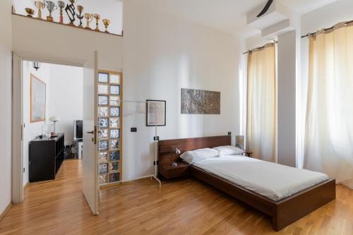 a bedroom with a bed and a wooden floor at Appartamento Gramsci by Wonderful Italy in Bologna