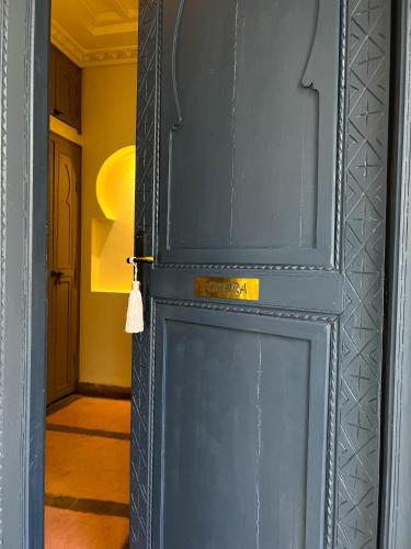 a blue door with a sign on it at Riad Jonan & Spa in Marrakech