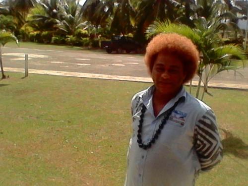 a woman is standing in a park at The Friendly North Inn in Labasa
