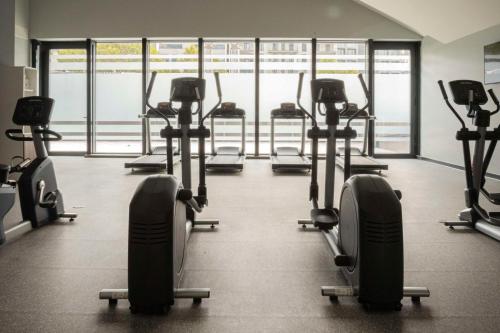 a gym with rows of tread machines in a room at Hilton Garden Inn Tbilisi Chavchavadze in Tbilisi City