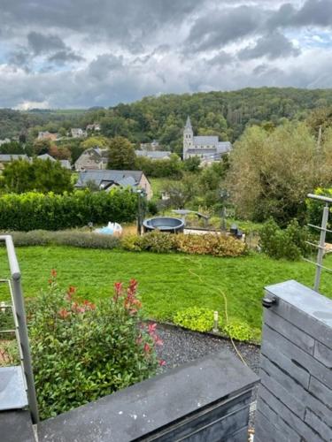 a view of a garden from a balcony of a house at B&B Le Bouchat-Oreille in Spontin