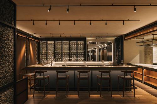 a bar in a wine cellar with stools at Hilton Singapore Orchard in Singapore