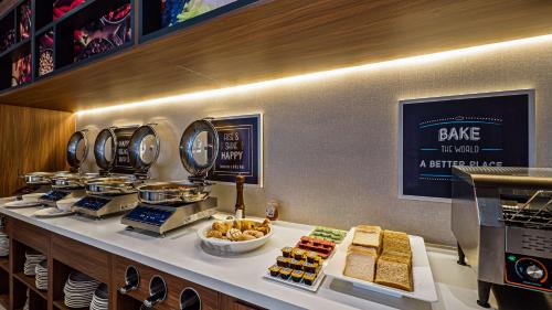 a buffet line with food on a counter in a restaurant at Hampton Inn By Hilton Nuevo Vallarta in Nuevo Vallarta 