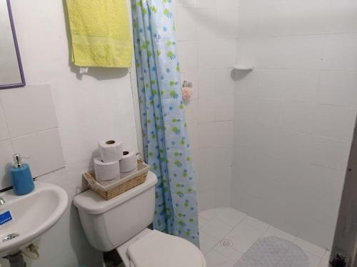 a bathroom with a toilet and a shower and a sink at Casa Colinas in Buenaventura