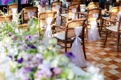 a row of chairs and tables with flowers at Conrad Shanghai in Shanghai
