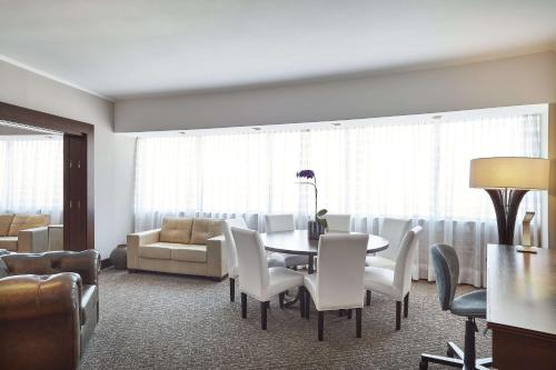 a dining room with a table and chairs at Hilton Porto Alegre, Brazil in Porto Alegre