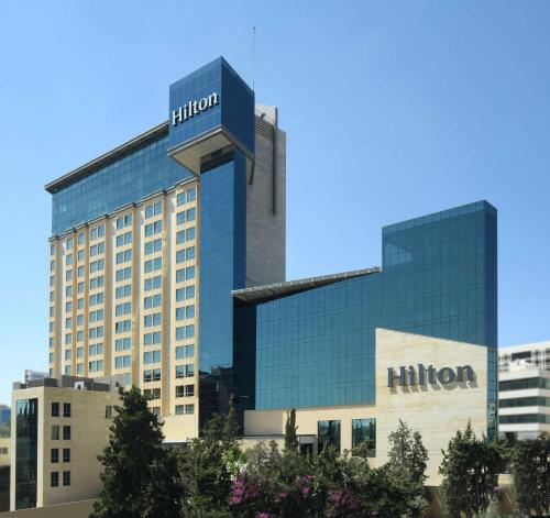 a building with a hilton sign on top of it at Hilton Amman in Amman