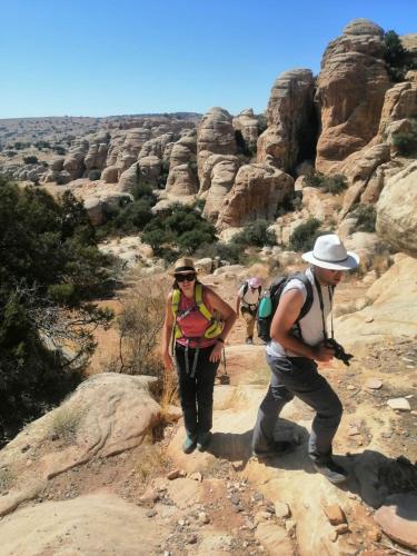 a group of people walking on a trail in the desert at - Trekking from Dana to Petra in Dana