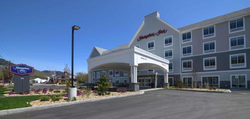 a hotel building with a sign in front of it at Hampton Inn Lincoln White Mountains in Lincoln
