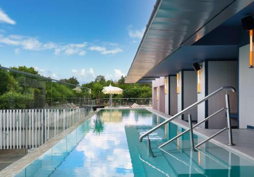 a swimming pool in the middle of a house at Hilton Garden Inn Evora in Évora