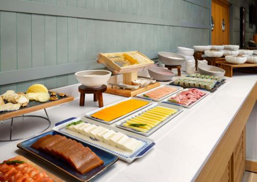 a buffet with many different types of food on a counter at Hilton Garden Inn Evora in Évora