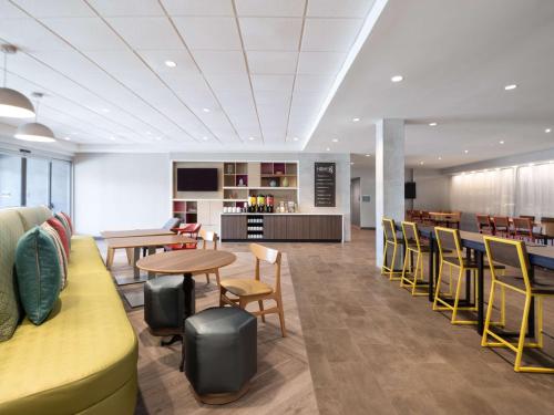 a cafeteria with tables and chairs and a counter at Home2 Suites By Hilton Santa Rosa Beach in Santa Rosa Beach