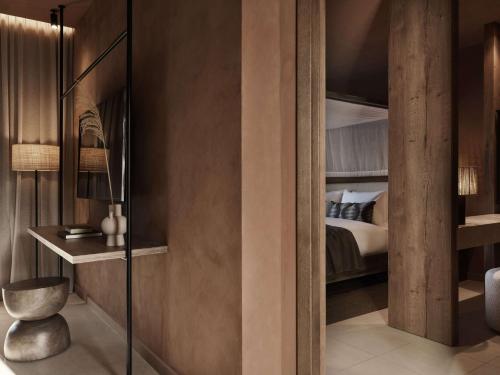 a hotel room with a bed and a bedroom with a closet at Lindian Village All Inclusive Resort Rhodes,Curio Collection in Kiotari