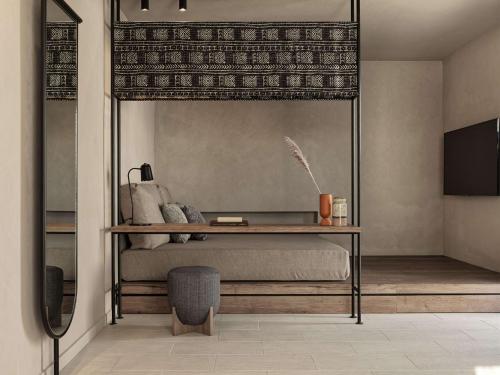 a bedroom with a canopy bed with a desk at Lindian Village All Inclusive Resort Rhodes,Curio Collection in Kiotari