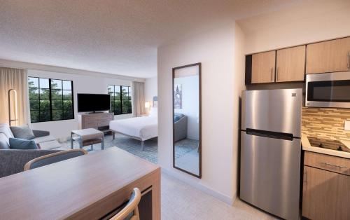 a kitchen and living room with a refrigerator and a room at Homewood Suites by Hilton Atlanta Buckhead Pharr Road in Atlanta