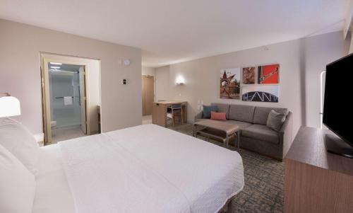 a hotel room with a bed and a couch at Homewood Suites by Hilton Atlanta Buckhead Pharr Road in Atlanta