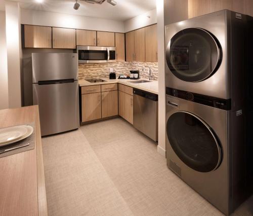 a kitchen with a washer and dryer in it at Homewood Suites by Hilton Atlanta Buckhead Pharr Road in Atlanta