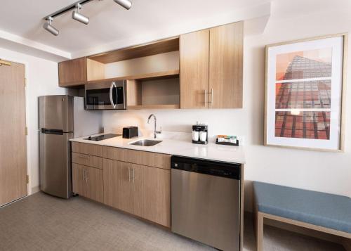 a kitchen with a sink and a refrigerator at Homewood Suites by Hilton Atlanta Buckhead Pharr Road in Atlanta