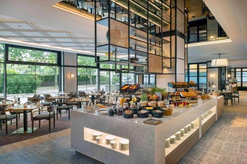 a restaurant with a buffet with tables and chairs at DoubleTree by Hilton Berlin Ku'damm in Berlin