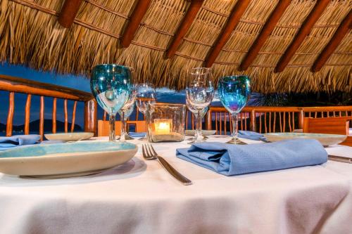 a table with a white table cloth and wine glasses at Hilton Grand Vacations Club Zihuatanejo in Zihuatanejo