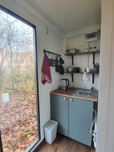 a small kitchen with a sink and a window at Domek Hrabiego -domek nr 1 in Rozkochów